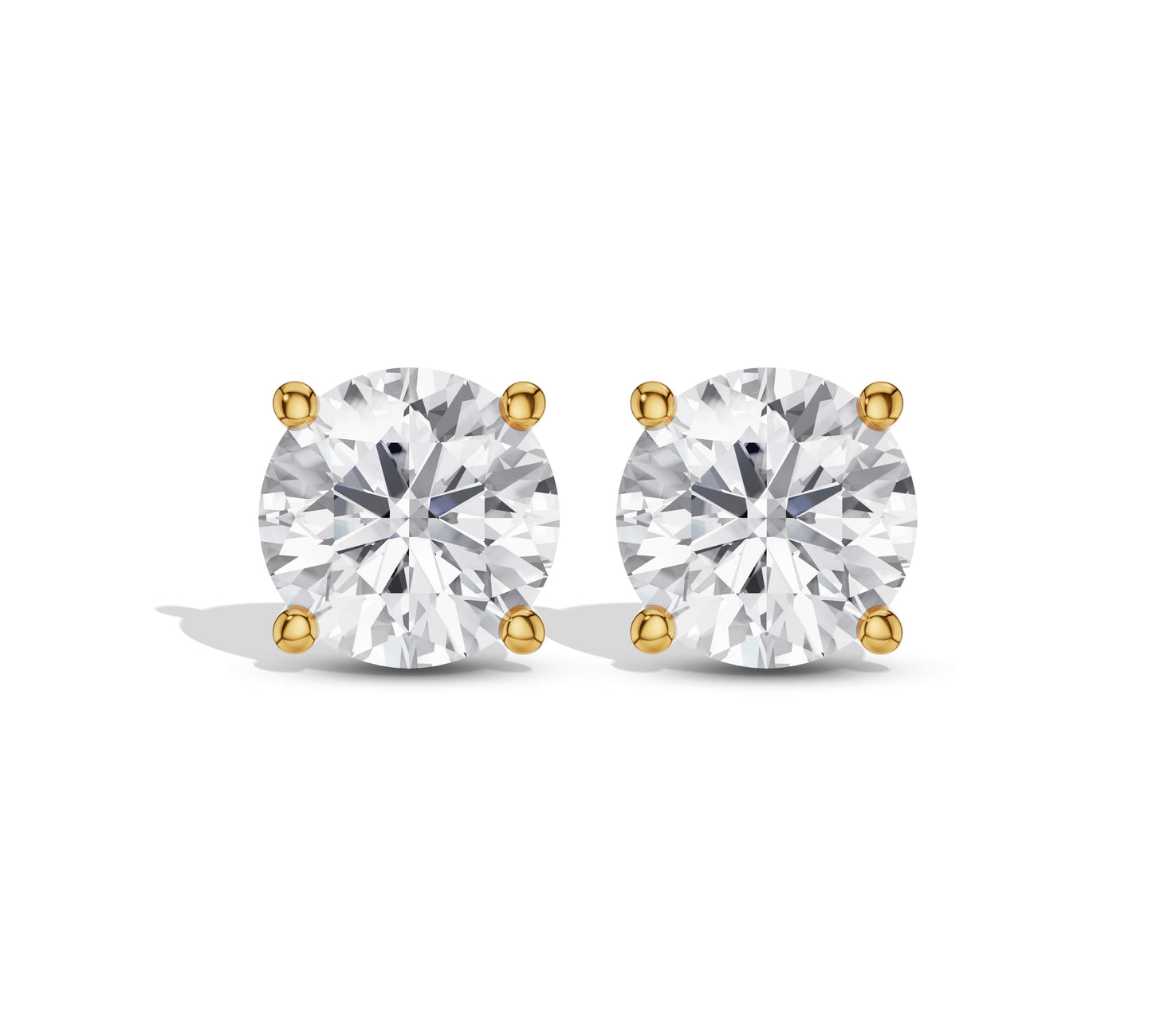 Close-up of classic round diamond stud earrings in yellow gold