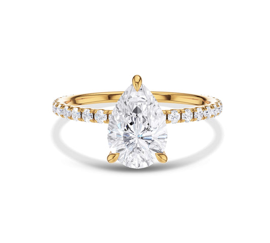 Pear-shaped diamond ring with pavé band in yellow gold