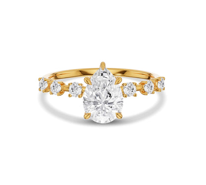 Pear shaped center diamond ring in yellow gold