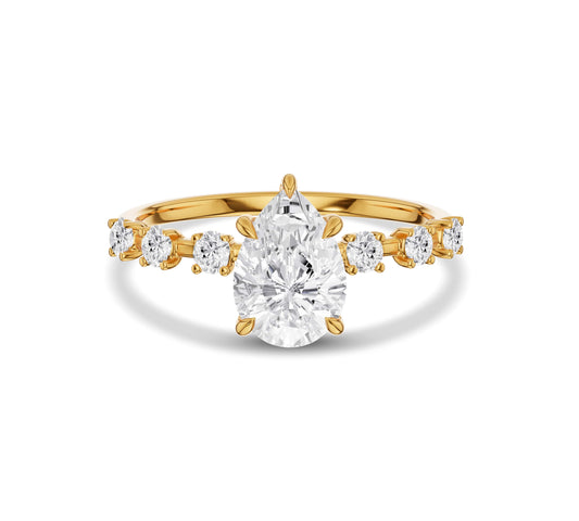 Pear shaped center diamond ring in yellow gold