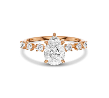 Rose gold pear shape engagement ring with side diamonds