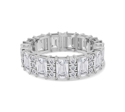 Emerald and round diamond gold eternity band with intricate craftsmanship