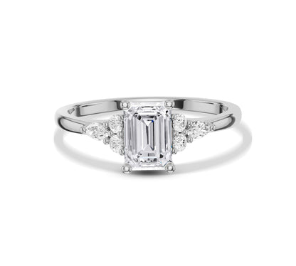 Emerald cut solitaire ring with pavé diamonds in white gold