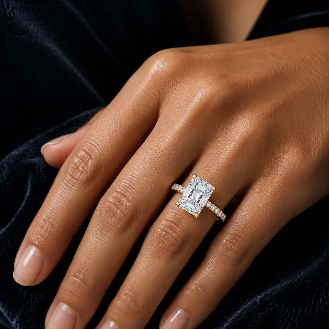 Radiant cut hidden halo engagement ring with pavé diamond band in yellow gold, featuring a sparkling moissanite or lab-grown diamond center stone and hidden halo setting by Frigus Jewelry.