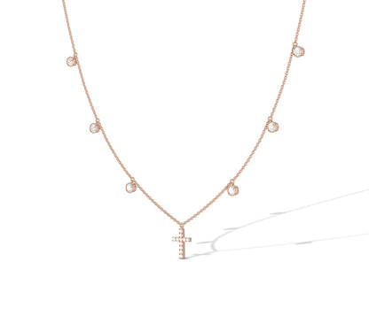 Elegant rose gold charm necklace with cross centerpiece