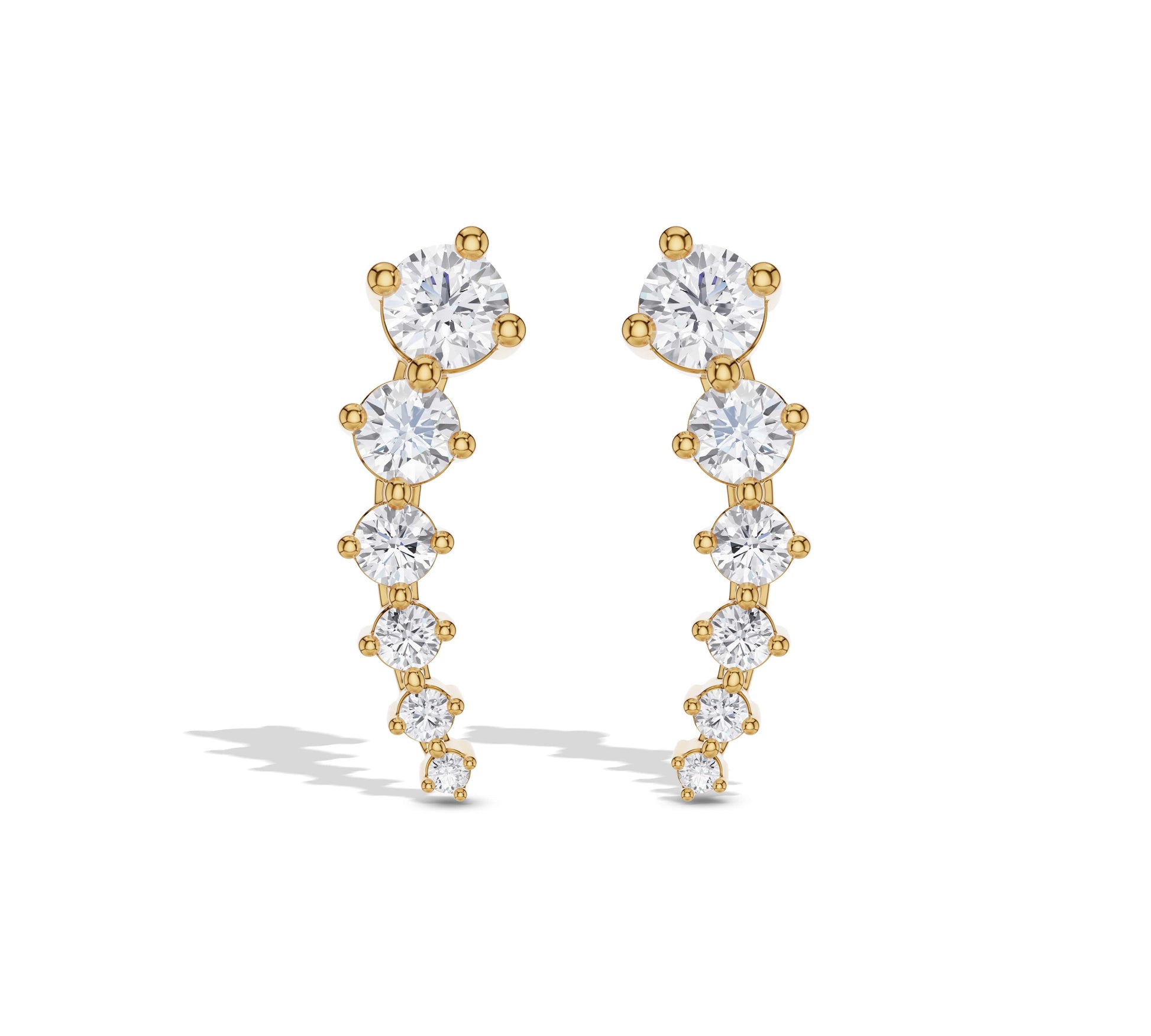 Long graduated diamond earrings in yellow gold