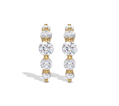 Graduated diamond hoop earrings in yellow gold
