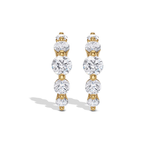 Graduated diamond hoop earrings in yellow gold