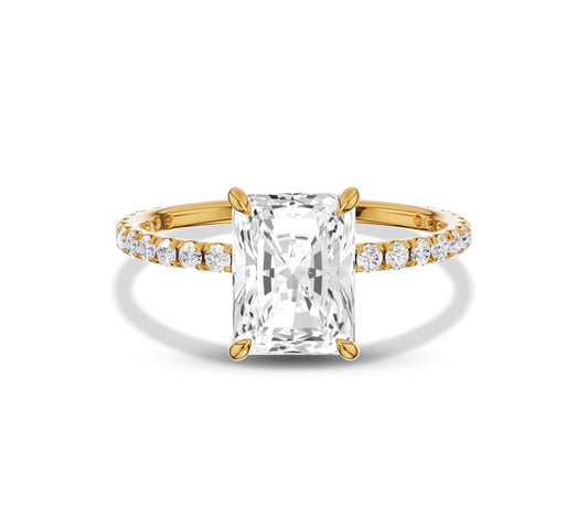 Radiant cut diamond ring with pavé diamond band in yellow gold