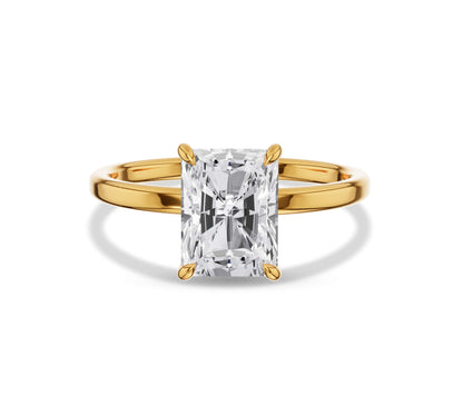 Solitaire radiant cut diamond ring with polished gold band