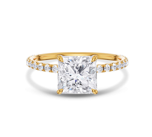 Pear shaped diamond ring with pavé band in yellow gold