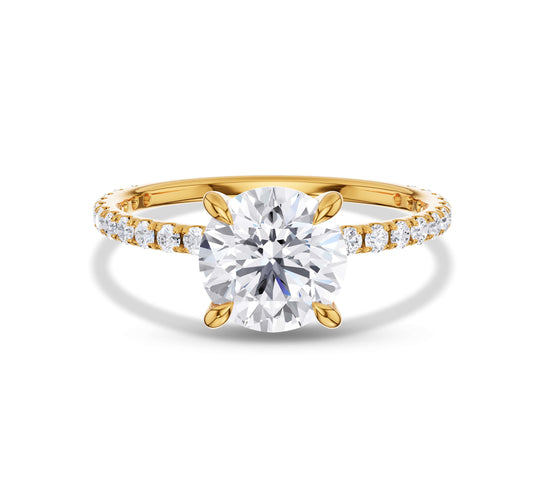 Round brilliant solitaire diamond ring with pavé gold band