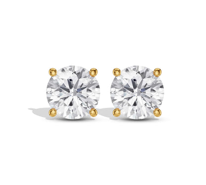 Close-up of classic round diamond stud earrings in yellow gold