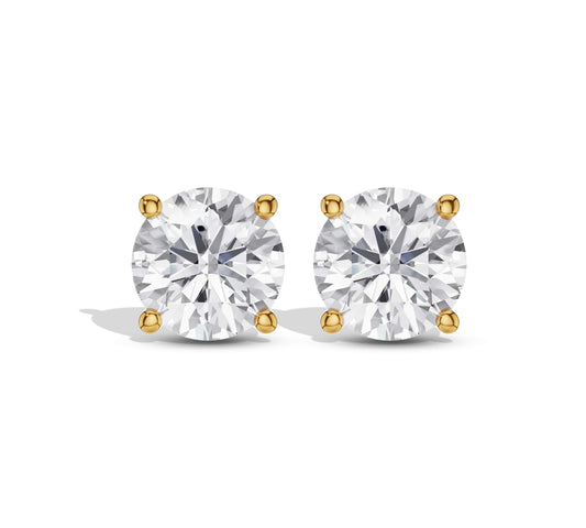 Close-up of classic round diamond stud earrings in yellow gold