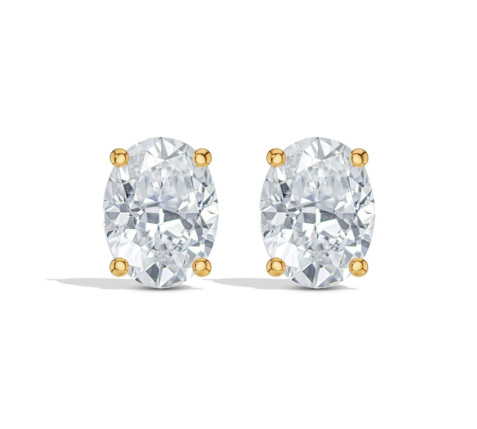 Oval diamond studs with four-prong gold setting