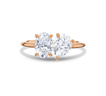 Rose gold Toi et Moi ring featuring oval and pear moissanite stones