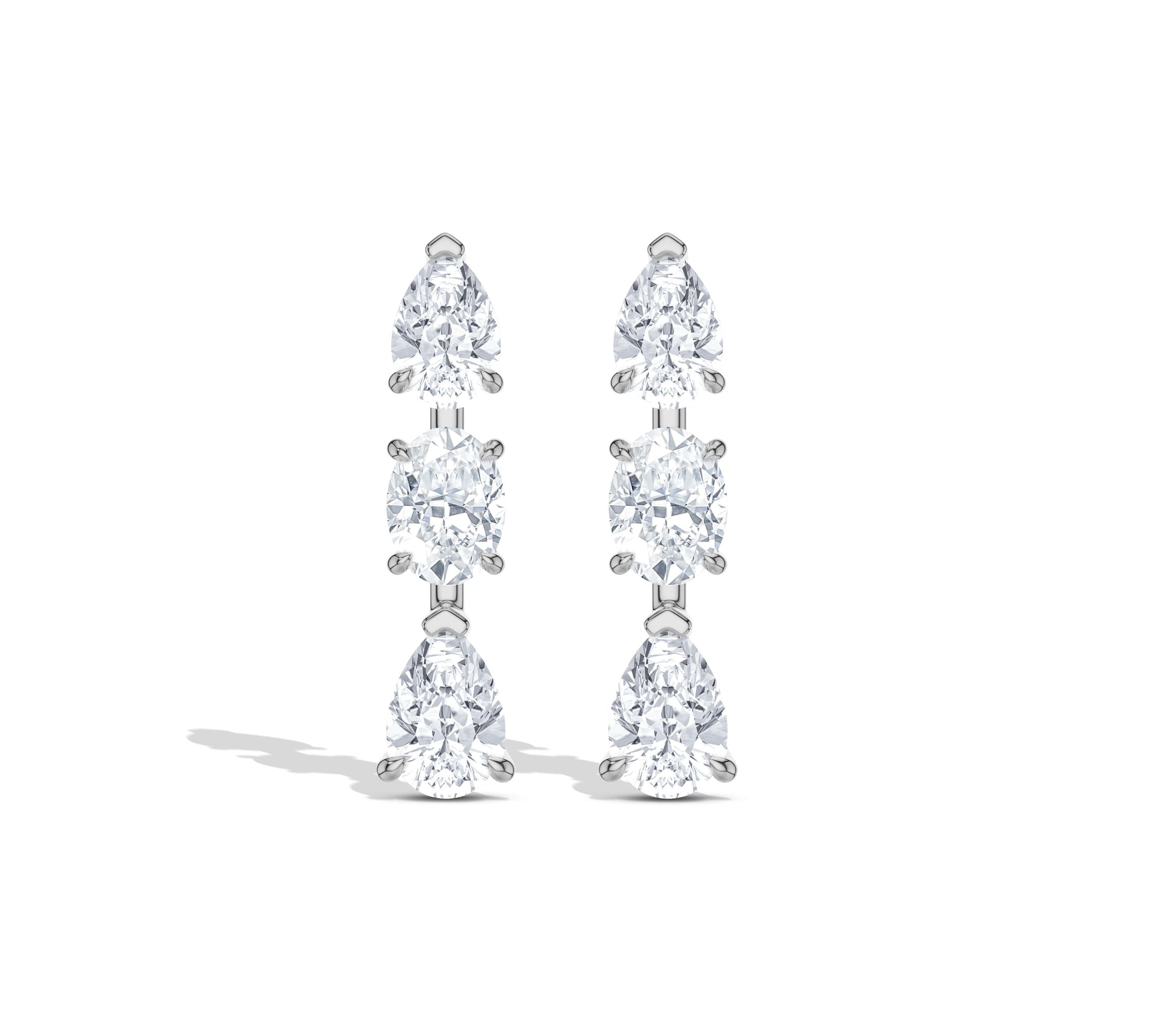 Delicate gold drop earrings with three sparkling stones